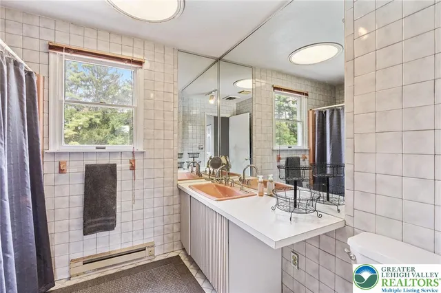 a bathroom with a sink double vanity and a shower