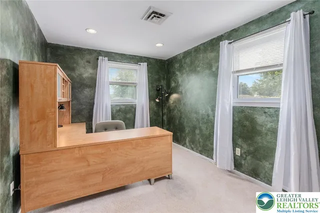 a bedroom with windows and closet