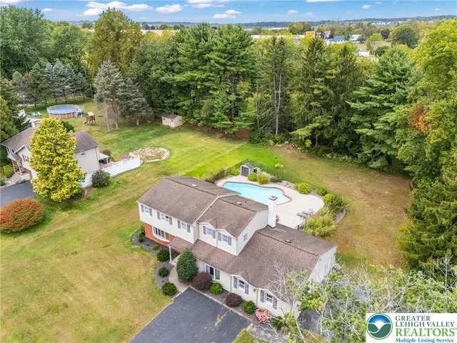 a view of a swimming pool with a yard