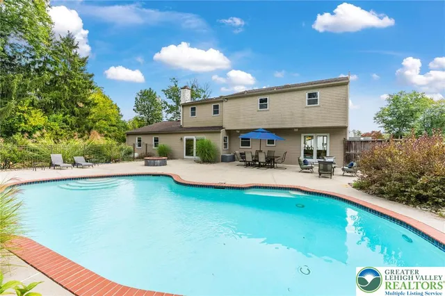 a view of swimming pool with seating area and garden