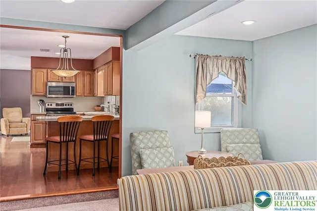 a bedroom with a bed and a view of kitchen