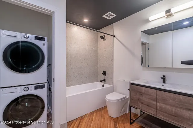 a bathroom with a toilet a sink and bathtub