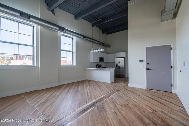 a view of a room with wooden floor