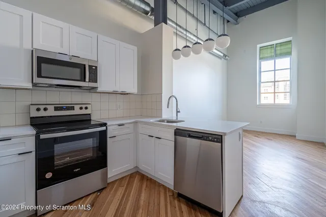 a view of a kitchen with wooden floor