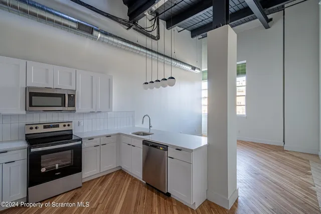 a view of a hallway with storage and utility