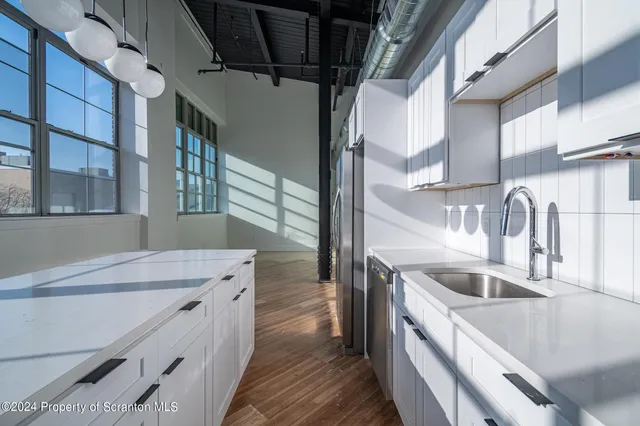a view of a room with wooden floor