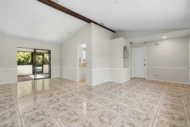 a view of empty room with window and ceiling fan
