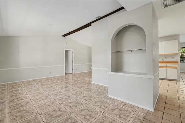 an empty room with entrance and windows