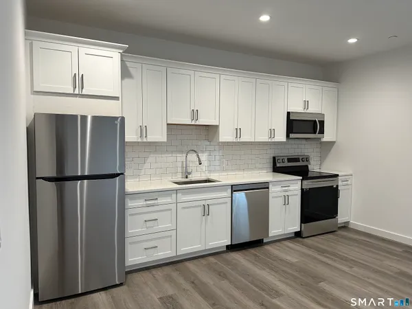 a kitchen with a refrigerator stove and microwave