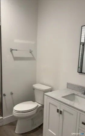 a white toilet sitting next to a bathroom sink
