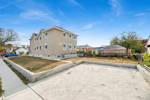 a view of swimming pool with outdoor seating and house in the background