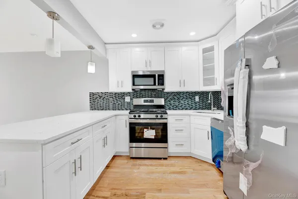 a kitchen with stainless steel appliances granite countertop a stove and a refrigerator