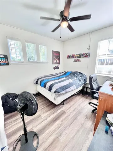 a bedroom with a bed and a chair