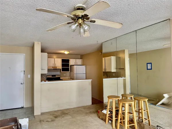 a kitchen with stainless steel appliances kitchen island granite countertop a refrigerator and a stove