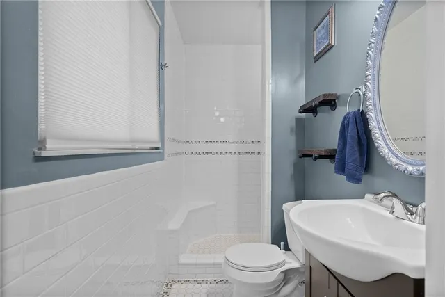 a bathroom with a sink toilet and shower