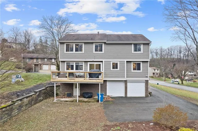 a view of a house with backyard and sitting area