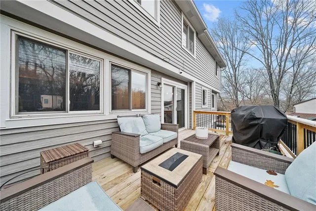 a view of a patio with couches chairs and large wooden floor