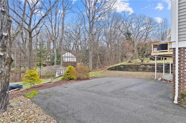 a view of backyard with a table and chairs and wooden fence