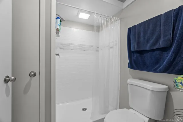 a white toilet sitting next to a bathroom sink