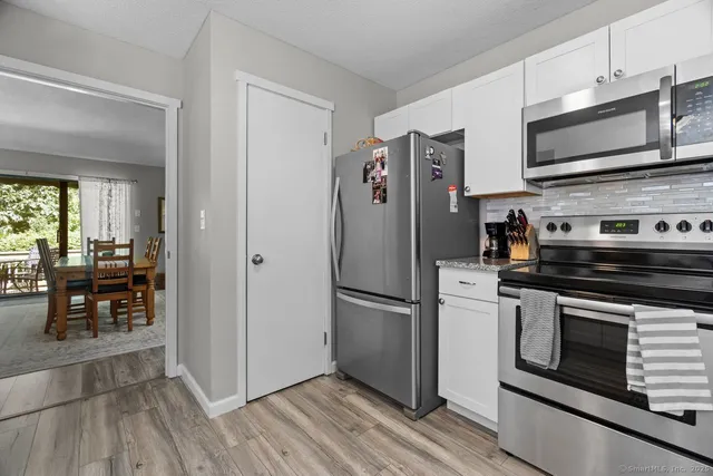 a kitchen with stainless steel appliances a refrigerator stove and microwave