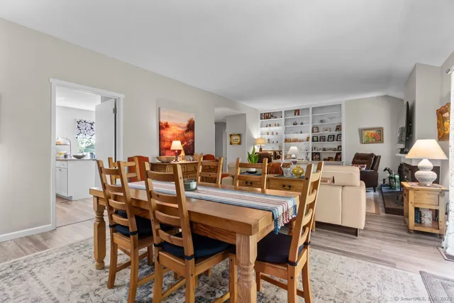 a dining room with furniture and wooden floor
