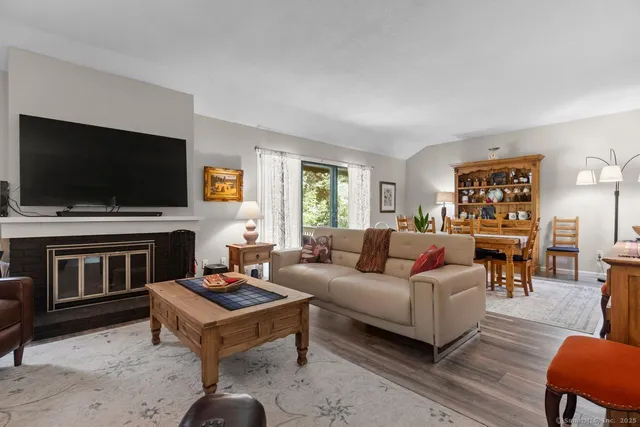 a living room with fireplace furniture and a flat screen tv