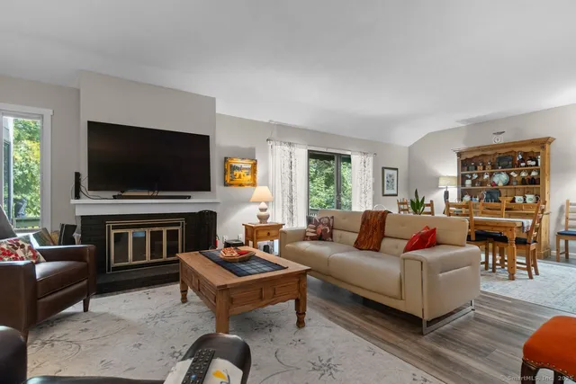 a living room with fireplace furniture and a flat screen tv