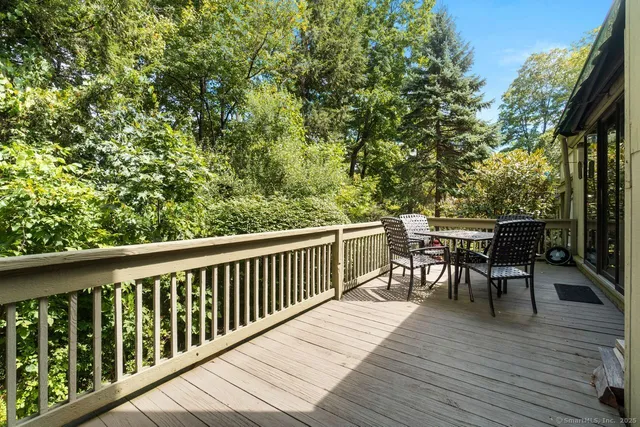 a view of a deck with chairs a barbeque with wooden floor and fence