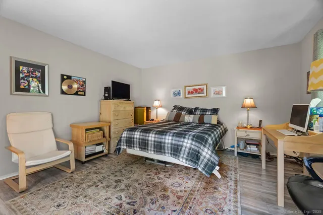 a bedroom with a bed and a chair