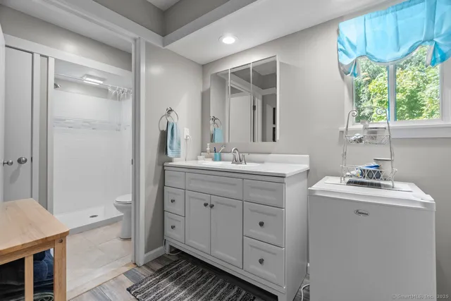a bathroom with a double vanity sink a mirror and a bathtub