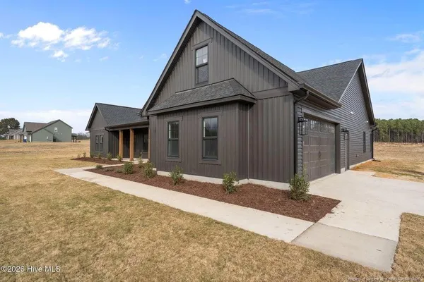 a front view of a house with a yard and garage