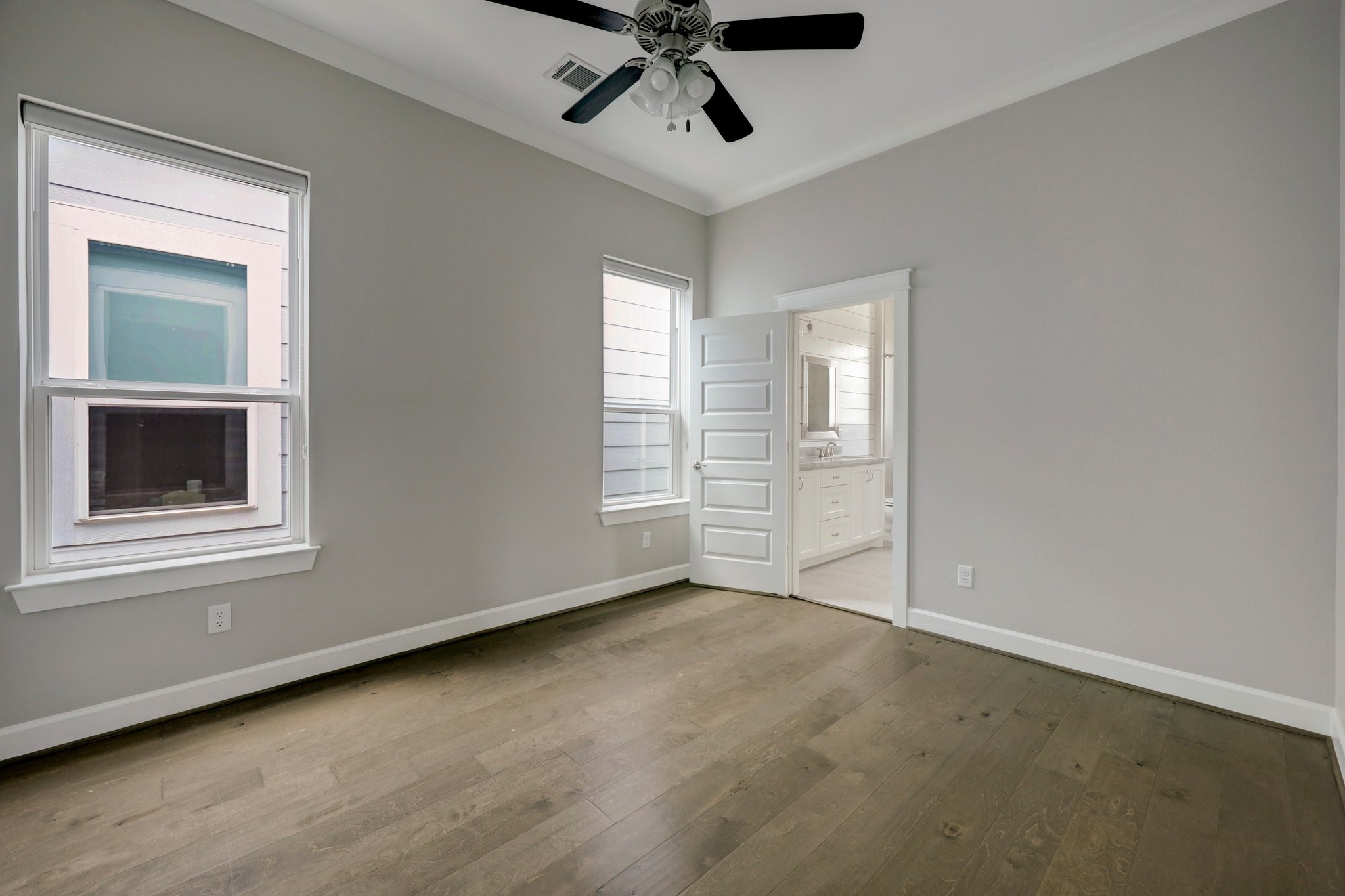 5233 Larkin Street, Unit A Houston, TX 77007 - Photo 13 of 15 an empty room with windows and ceiling fan