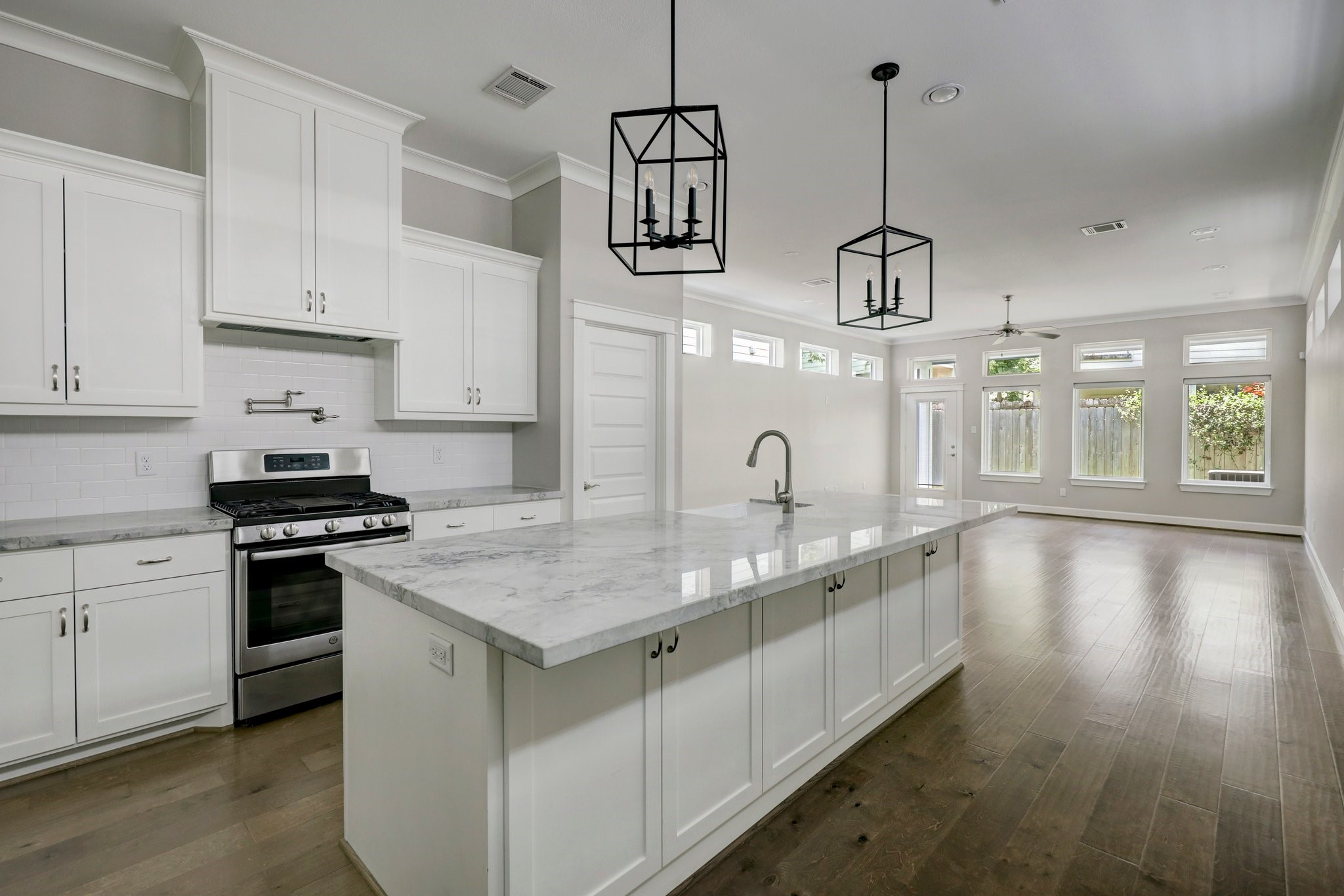 5233 Larkin Street, Unit A Houston, TX 77007 - Photo 3 of 15 a kitchen with stainless steel appliances granite countertop a stove a sink dishwasher and a oven with white cabinets