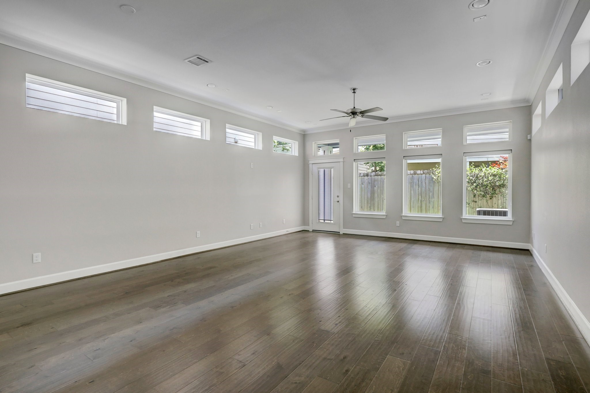 5233 Larkin Street, Unit A Houston, TX 77007 - Photo 5 of 15 a view of an empty room with wooden floor and a window