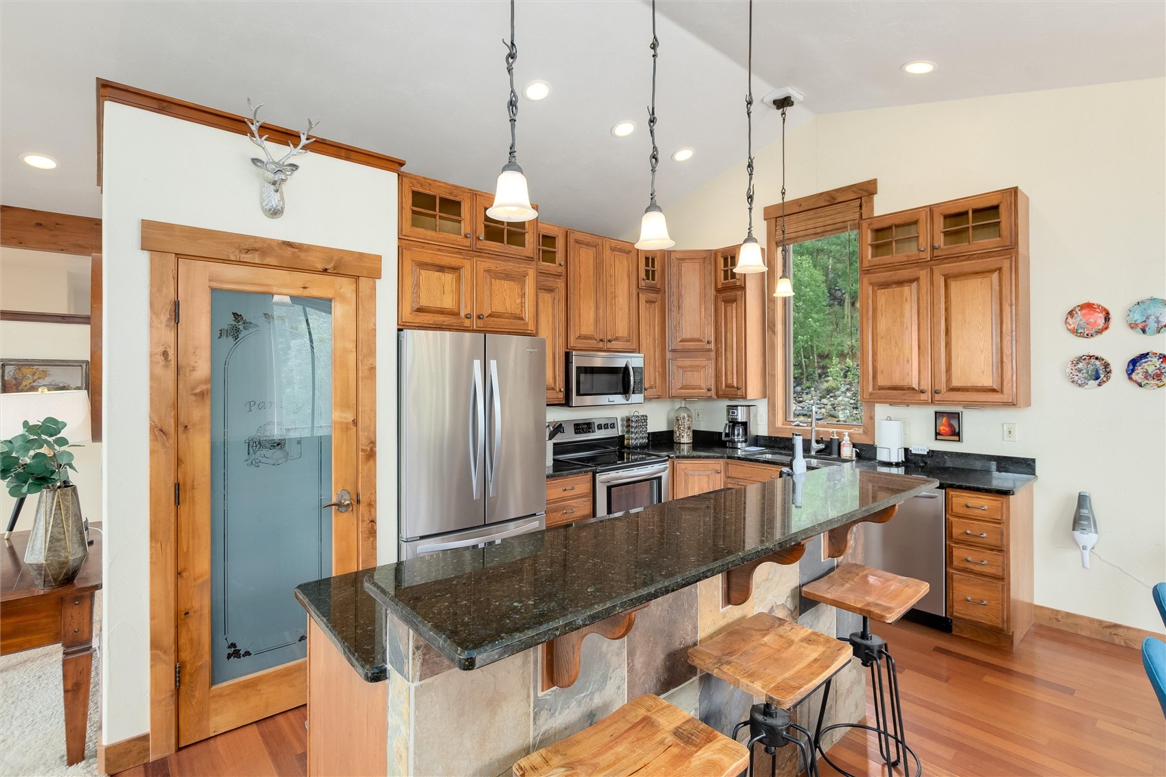 592 Ponderosa Road Fairplay, CO 80440 - Photo 19 of 45 a kitchen with stainless steel appliances granite countertop a refrigerator a oven a sink a dining table and chairs with wooden floor