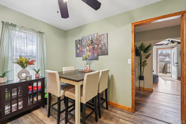 a view of a dining room with furniture and wooden floor