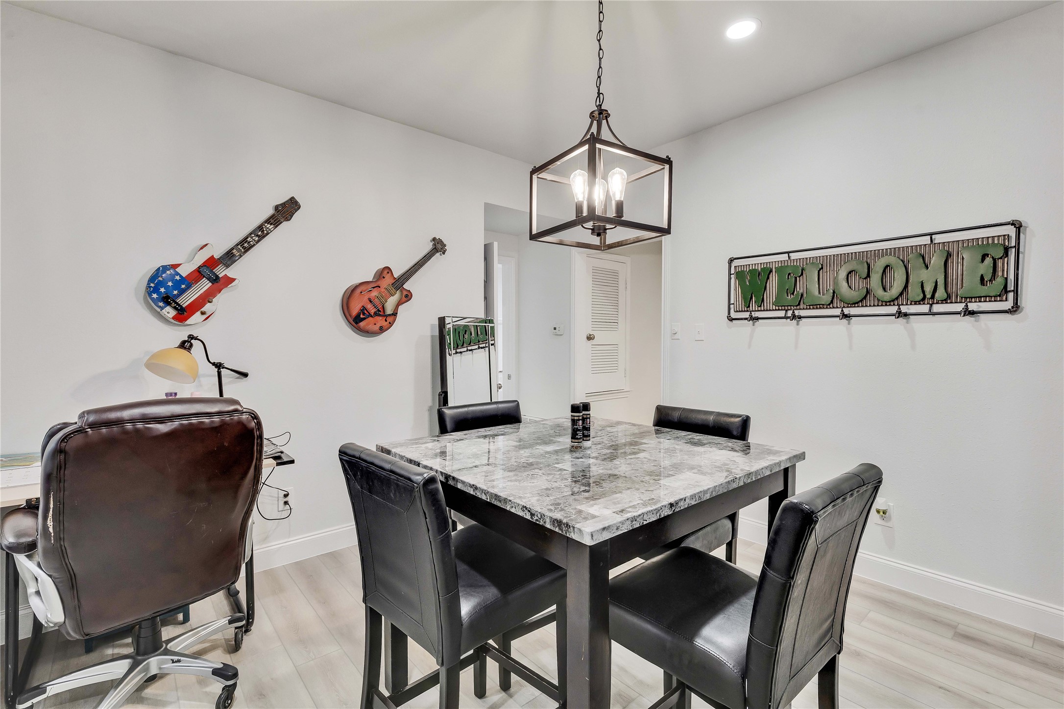 2529 Rio Grande Street, Unit 56 Austin, TX 78705 - Photo 5 of 16 Dining space featuring baseboards, an inviting chandelier, and light wood-type flooring