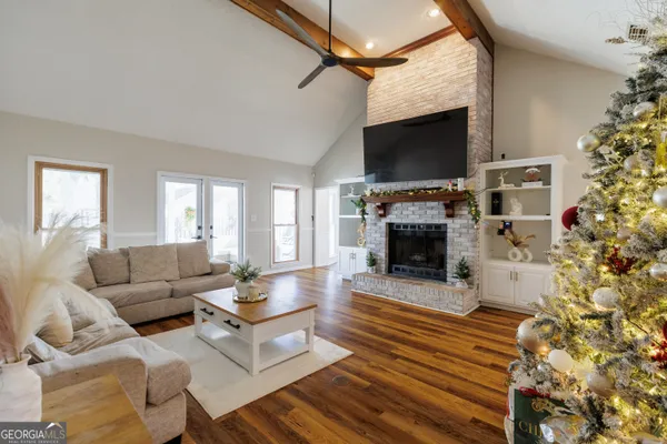 a view of a room with wooden floor and potted plant