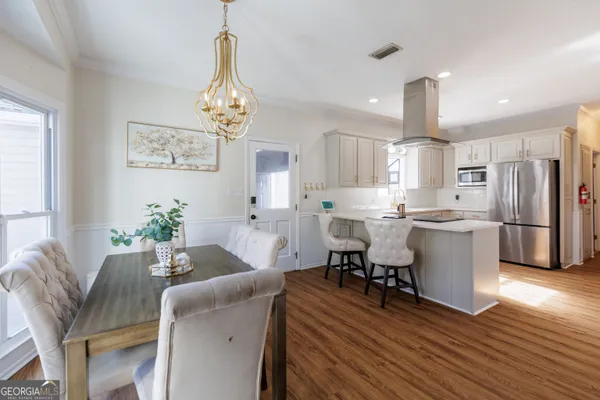 a kitchen with a sink a stove and cabinets