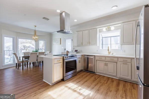 a view of a dining room with furniture window wooden floor and a chandelier
