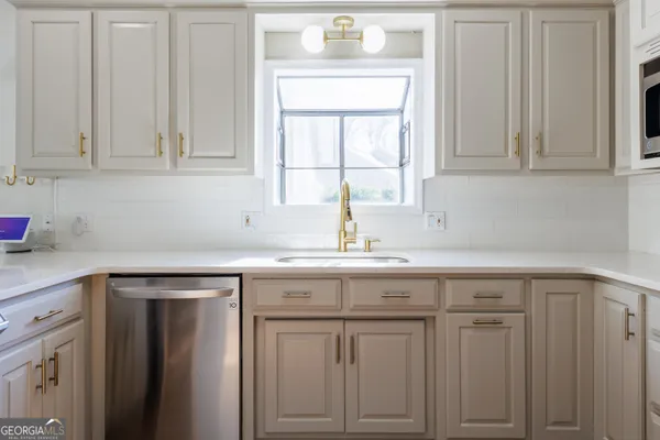 a spacious bathroom with a tub sink and mirror