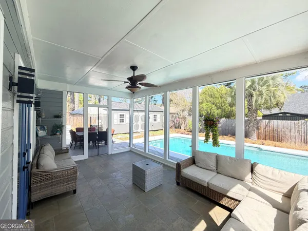 a view of a dining room with furniture and chandelier