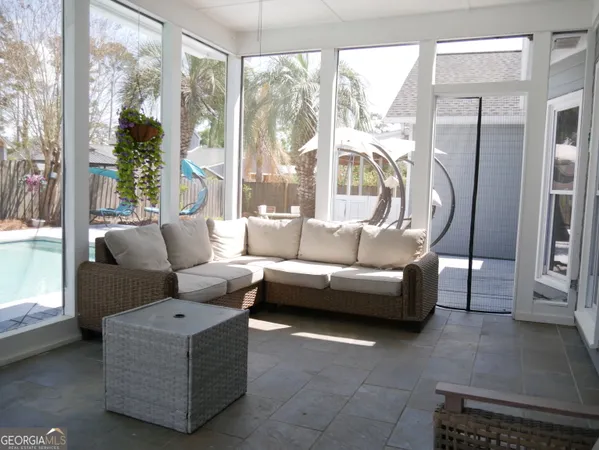 a view of a lounge chair and table in the backyard