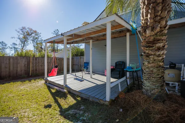 a view of a house with swimming pool and sitting area