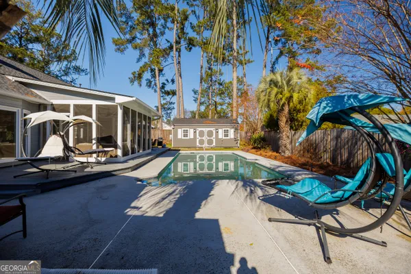 a view of a house with swimming pool and porch