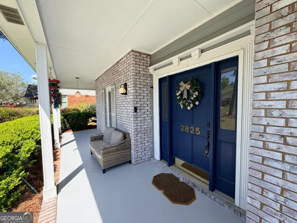 a backyard of a house with outdoor seating