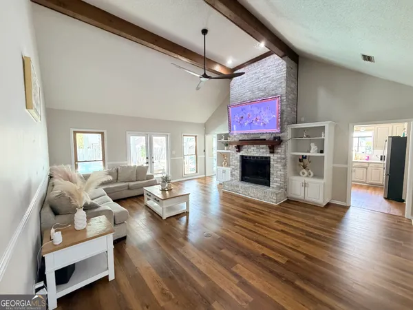 a living room with furniture and a flat screen tv