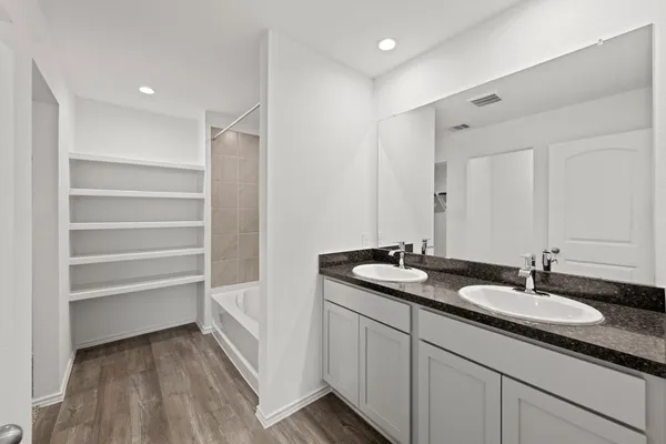 a bathroom with a sink double vanity and a mirror