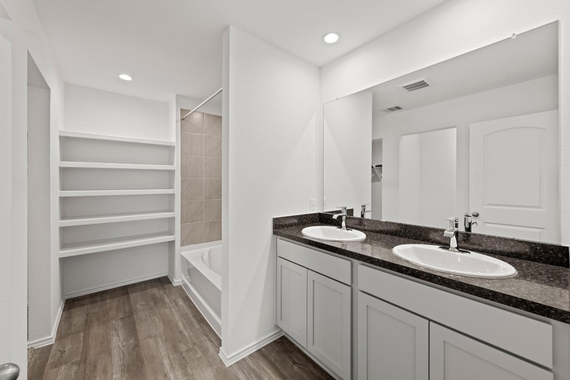 5710 Sycamore Glen Dr Spring Spring, TX 77373 - Photo 12 of 18 a bathroom with a sink double vanity and a mirror
