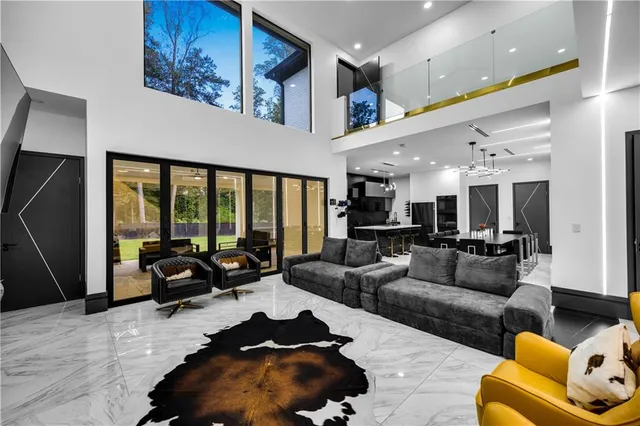 a living room with furniture and large windows